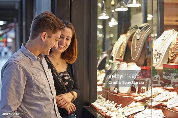 happy couple looking at jewelry shop window - jeweller bildbanksfoton och bilder