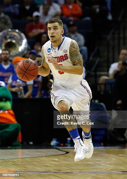 Scottie Wilbekin of the Florida Gators brings the ball up the floor against the UCLA Bruins during a regional semifinal of the 2014 NCAA Men's...