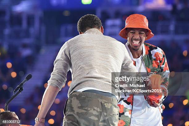 Player Stephen Curry accepts award for Best Male Athlete from TV personality Nick Cannon onstage at the Nickelodeon Kids' Choice Sports Awards 2015...