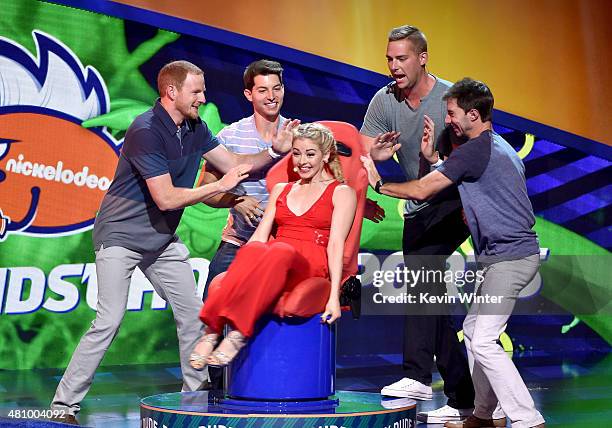 Olympic figure skater Gracie Gold rides the Dizzy Dude with members of Dude Perfect at the Nickelodeon Kids' Choice Sports Awards 2015 at UCLA's...