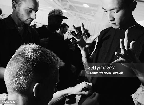 Model prepares backstage at the Siki Im fashion show during New York Fashion Week: Men's S/S 2016 at Skylight Clarkson Sq during New York Fashion...