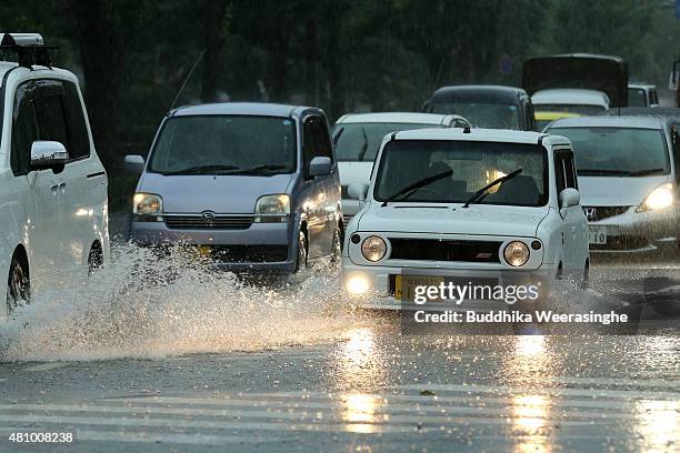Vehicles drive among the flooded road during the heavy rain and wind delivered by typhoon Nangka on July 17, 2015 in Himeji, Japan. As Typhoon Nangka...