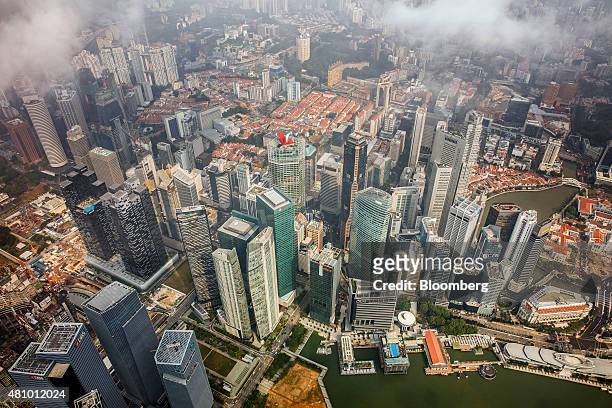 Commercial buildings in the central business district stand near Marina Bay in this aerial photograph taken above Singapore, on Thursday, July 2,...