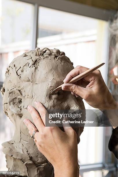 woman working on clay bust - moulant photos et images de collection