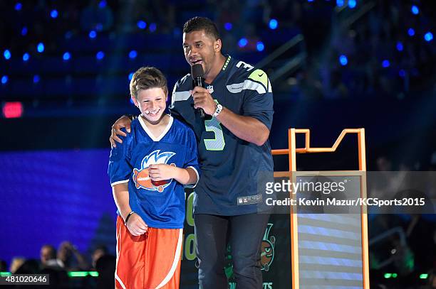 Pokoj and host Russell Wilson play a football game onstage at the Nickelodeon Kids' Choice Sports Awards 2015 at UCLA's Pauley Pavilion on July 16,...