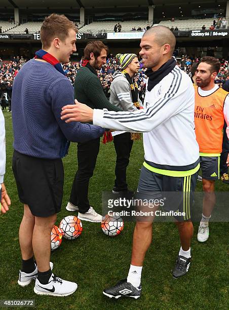 Jack Trengrove of the Melbourne Demons meets Pepe of Real Madrid during a Real Madrid training session at Melbourne Cricket Ground on July 17, 2015...
