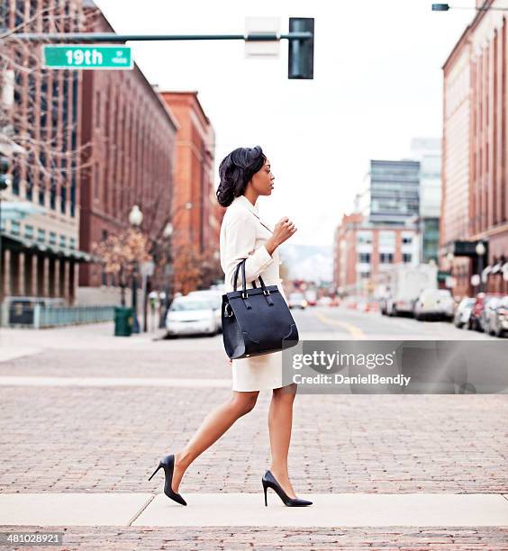 businesswoman walking in city - denver street stock pictures, royalty-free photos & images