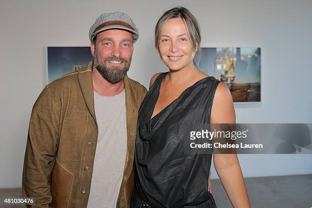 Photographer Brian Bowen Smith and Shea Bowen Smith attend the 'Desert Voices' opening exhibition at De Re Gallery on July 16, 2015 in West...