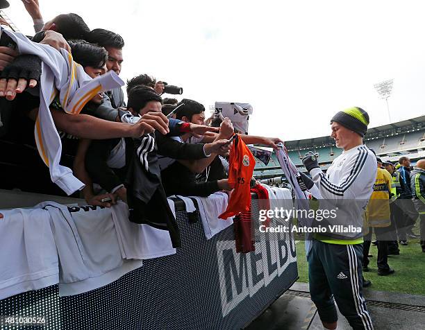 Toni Kroos of Real Madrid signs autographs during a Real Madrid training session at Melbourne Cricket Ground on July 17, 2015 in Melbourne,...