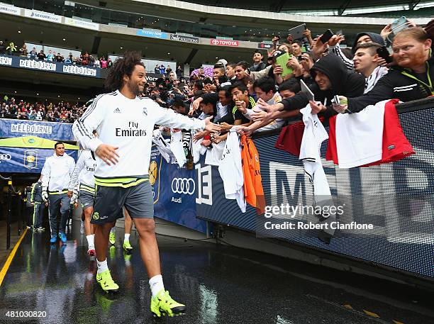 Marcelo of Real Madrid acknowledges fans as he arrives during a Real Madrid training session at Melbourne Cricket Ground on July 17, 2015 in...