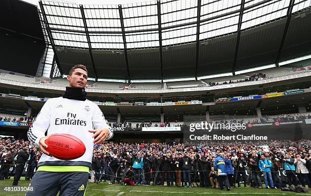 Christiano Ronaldo of Real Madrid kicks an Aussie Rules football during a Real Madrid training session at Melbourne Cricket Ground on July 17, 2015...