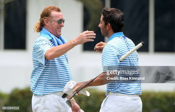Miguel Angel Jimenez and Pablo Larrazabal of Team Europe celebrate after the foursome matches on day two of the EurAsia Cup at Glenmarie G&CC on...
