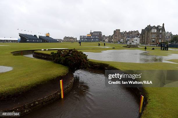 View of the flooded 18th hole fairway and Swilcan Bridge as rain falls prior to the second round of the 144th Open Championship at The Old Course on...