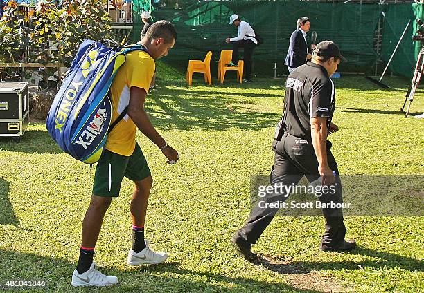 Nick Kyrgios of Australia leaves the arena after losing his match against Aleksandr Nedovyesov of Kazakhstan as Pat Rafter looks on during day one of...