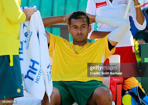 Nick Kyrgios of Australia looks on as he sits in his chair in between games in his match against Aleksandr Nedovyesov of Kazakhstan during day one of...