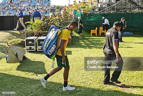 Nick Kyrgios of Australia leaves the arena after losing his match against Aleksandr Nedovyesov of Kazakhstan as Pat Rafter looks on during day one of...