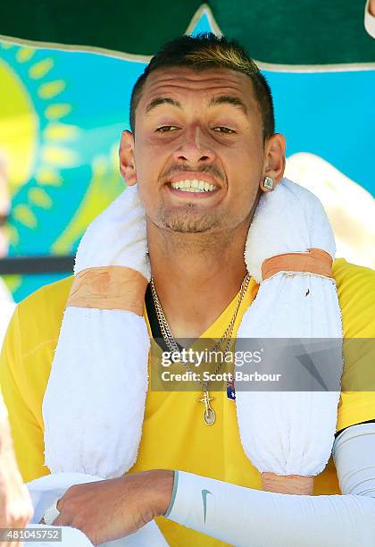 Nick Kyrgios of Australia looks on as he sits in his chair in between games in his match against Aleksandr Nedovyesov of Kazakhstan during day one of...
