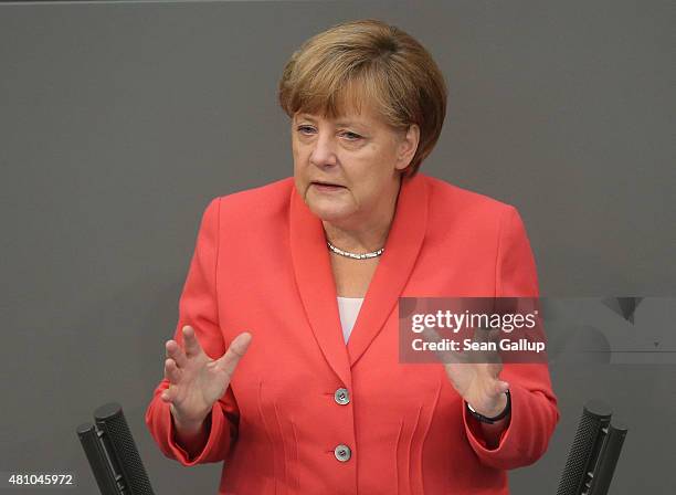 German Chancellor Angela Merkel speaks during debates prior to a vote over the third EU financial aid package to Greece at an extraordinary session...