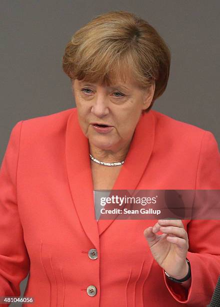 German Chancellor Angela Merkel speaks during debates prior to a vote over the third EU financial aid package to Greece at an extraordinary session...