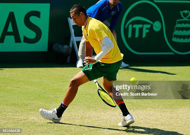 Nick Kyrgios of Australia plays a shot between hs legs in his singles match against Aleksandr Nedovyesov of Kazakhstan during day one of the Davis...