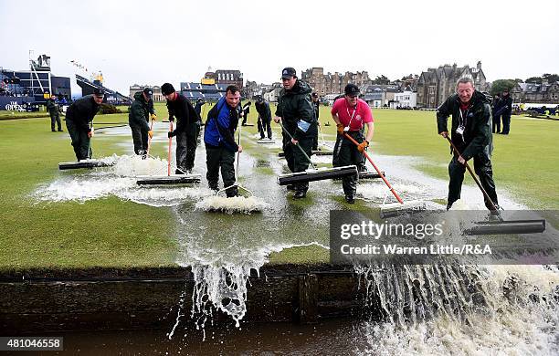 Greenstaff squeegee the 18th green during the second round of the 144th Open Championship at The Old Course on July 17, 2015 in St Andrews, Scotland.