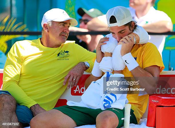 Thanasi Kokkinakis of Australia reacts as Wally Masur, captain of Australia speaks to him in between games in his singles match against Mikhail...