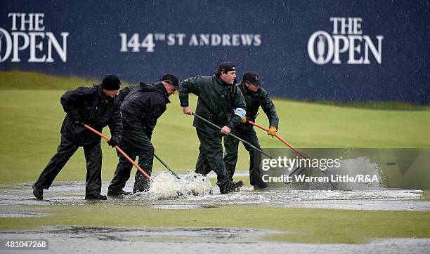 Greenstaff squeegee the 18th green during the second round of the 144th Open Championship at The Old Course on July 17, 2015 in St Andrews, Scotland.