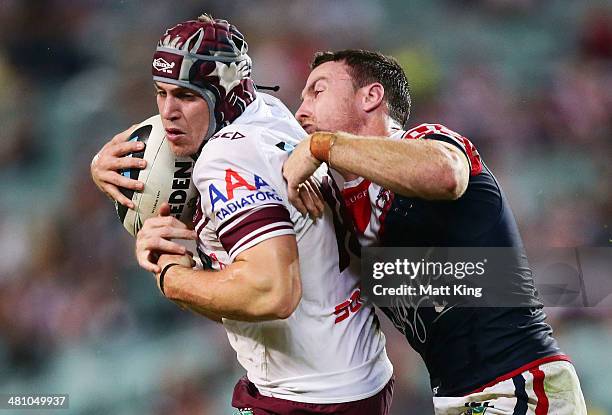 Jamie Buhrer of the Sea Eagles is tackled by James Maloney of the Roosters during the round four NRL match between the Sydney Roosters and the...