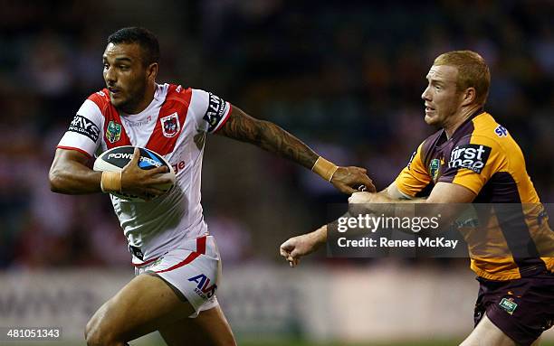 Dylan Farrell of the Dragons fends off the tackle of Jack Reed during the round four NRL match between the St George Illawarra Dragons and the...