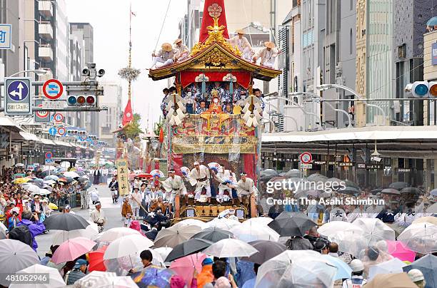 Yamahoko' float marches on in the rain due to the Typhoon Nangka approaching during the 'Yoiyama' of the Kyoto Gion Festival on July 17, 2015 in...