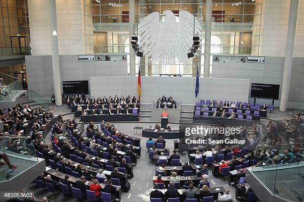 German Chancellor Angela Merkel speaks during debates prior to a vote over the third EU financial aid package to Greece at an extraordinary session...