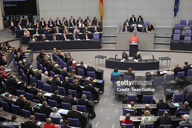 German Chancellor Angela Merkel speaks during debates prior to a vote over the third EU financial aid package to Greece at an extraordinary session...
