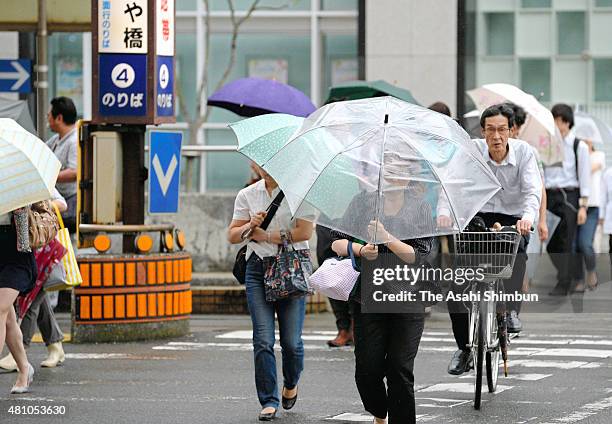Commuters walk in the rain as the Typhoon Nangka approaching on July 16, 2015 in Kochi, Japan. The typhoon is expected to hit Western Japan.