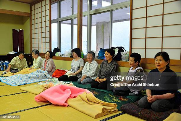 Local residents sit in the room as they precautiously evacuate as the Typhoon Nangka approaching on July 16, 2015 in Naka, Tokushima, Japan. The...