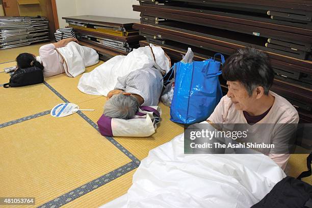 Local residents rest in the room as they voluntarily evacuate as the Typhoon Nangka approaching on July 16, 2015 in Kochi, Japan. The typhoon is...