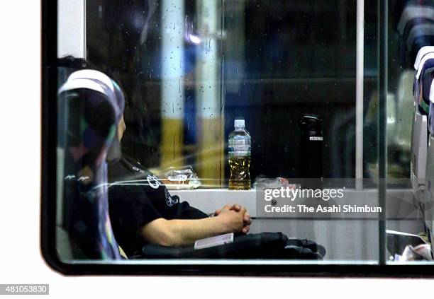 Man stay a night on the train as the service suspended as the Typhoon Nangka approaching on July 16, 2015 in Hachioji, Tokyo, Japan. The typhoon is...