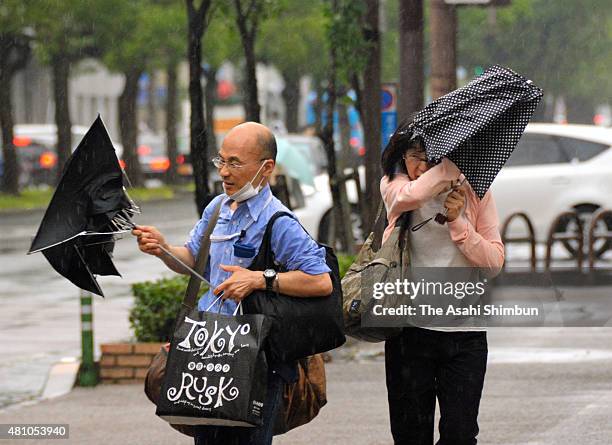 People struggle to hold umbrellas as the Typhoon Nangka approaching on July 16, 2015 in Takamatsu, Kagawa, Japan. The typhoon is expected to hit...