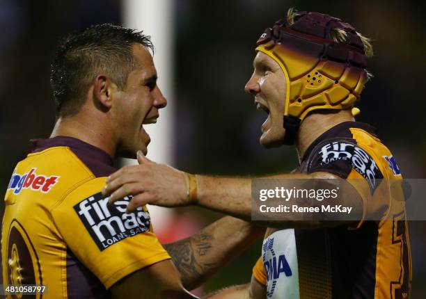 Todd Lowrie of the Broncos celebrates his try with team mate Corey Parker during the round four NRL match between the St George Illawarra Dragons and...