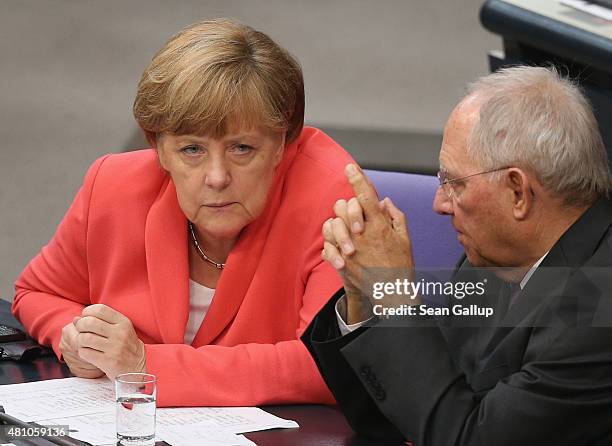 German Chancellor Angela Merkel and Finance Minister Wolfgang Schaeuble speak with one another during debates prior to votes over the third EU...