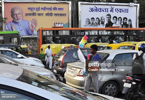 Hoardings of two main national parties BJP and Congress side by side with their official slogans Abkee Baar Modi Sarkaar of BJP and Anekta Me Ekta by...