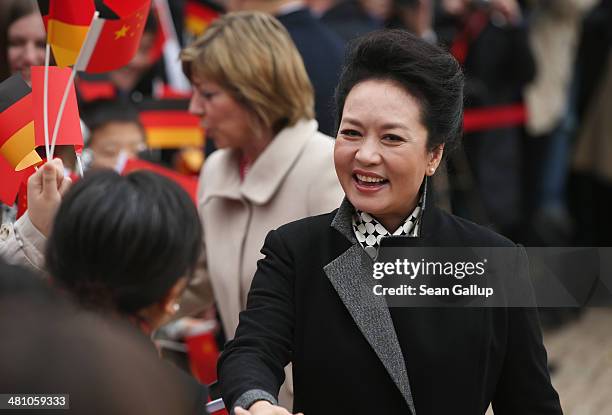 Chinese First Lady Peng Liyuan and German First Lady Daniela Schadt greet students at Schloss Bellevue on March 28, 2014 in Berlin, Germany. Chinese...