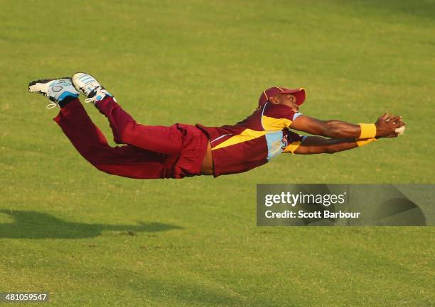 Dwayne Bravo the West Indies takes a diving catch in the outfield to dismiss James Faulkner of Australia during the ICC World Twenty20 Bangladesh...