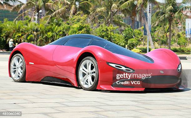 Twenty-seven-year auto enthusiast Chen Yinxi tests drive his self-made electric SportsCar at square of Hainan International Convention And Exhibition...