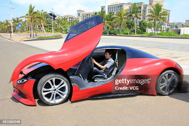 Twenty-seven-year auto enthusiast Chen Yinxi drives his self-made electric SportsCar at square of Hainan International Convention And Exhibition...