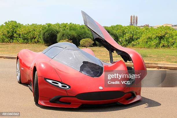 Twenty-seven-year auto enthusiast Chen Yinxi drives his self-made electric SportsCar at square of Hainan International Convention And Exhibition...