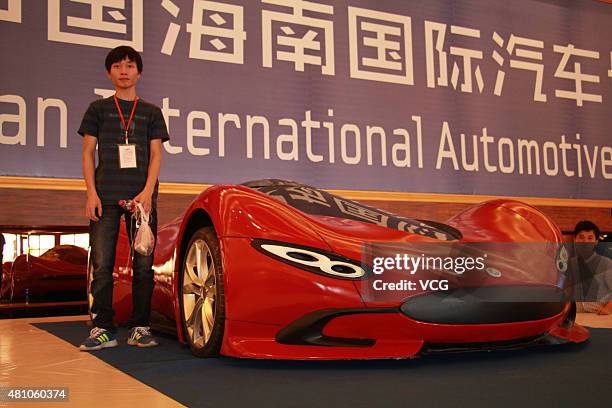 Twenty-seven-year auto enthusiast Chen Yinxi poses with his self-made electric SportsCar during the Hainan International Convention And Exhibition...