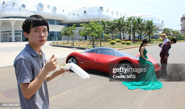 Couple of lovers shoot wedding photos with twenty-seven-year auto enthusiast Chen Yinxi 's self-made electric SportsCar at square of Hainan...