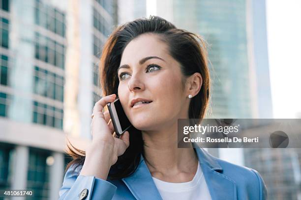successful businesswoman on the phone in urban landscape - russian ethnicity stock pictures, royalty-free photos & images