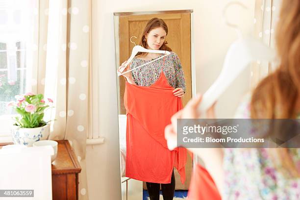 young women trying on clothes - full length mirror stock pictures, royalty-free photos & images