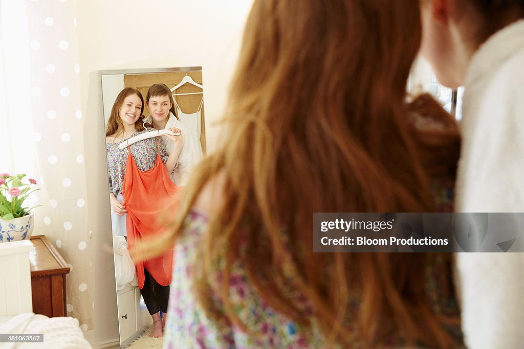 Two friends deciding what clothes to wear